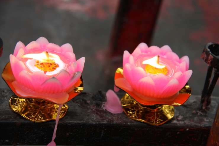 Candles at a temple shrine in a hutong, Beijing, China